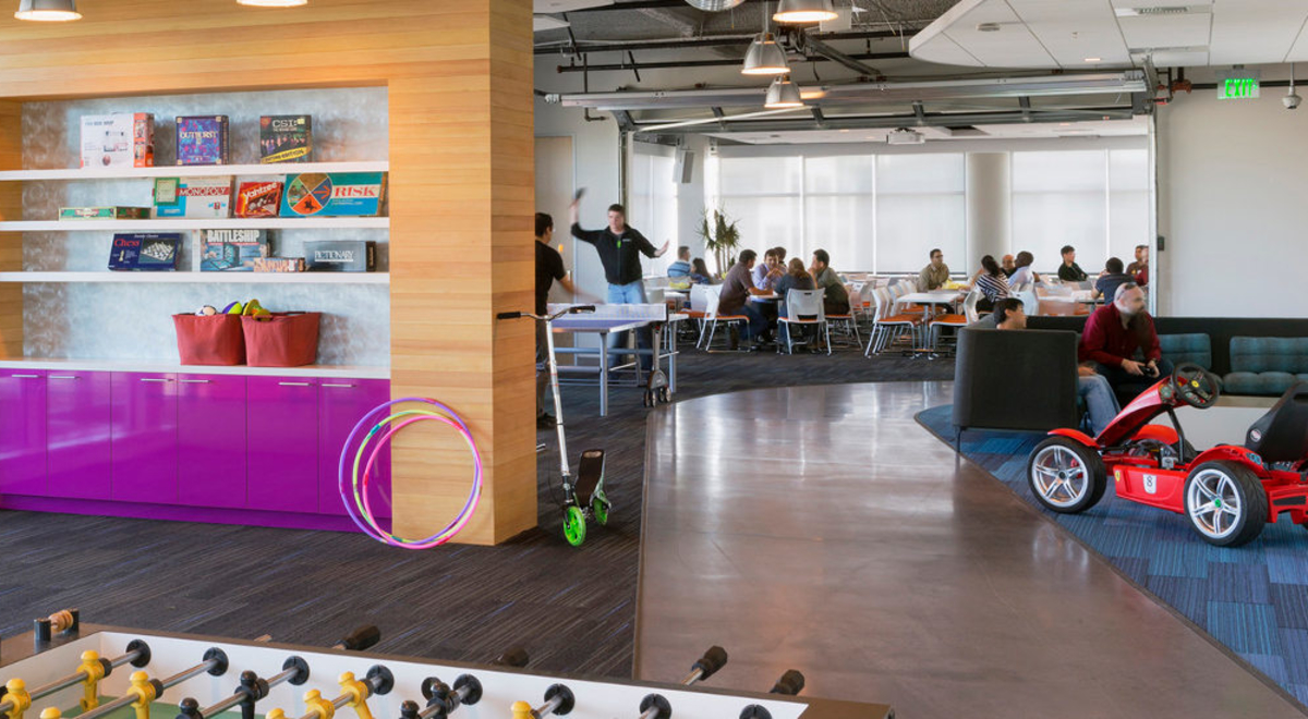 People enjoying an entertainment room with table tennis, board games and video games