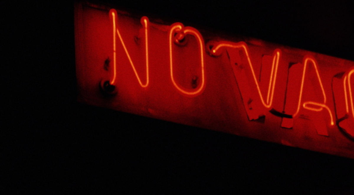 No vacancy indicated by a red neon light sign