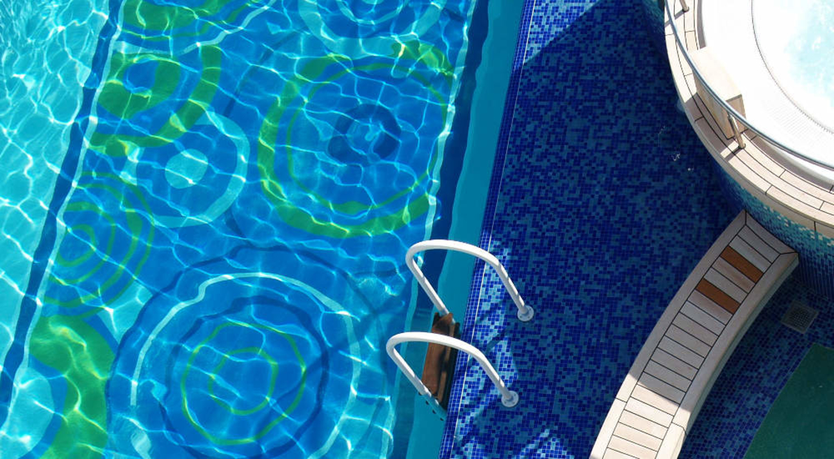 Pool side with white jacuzzi on the side