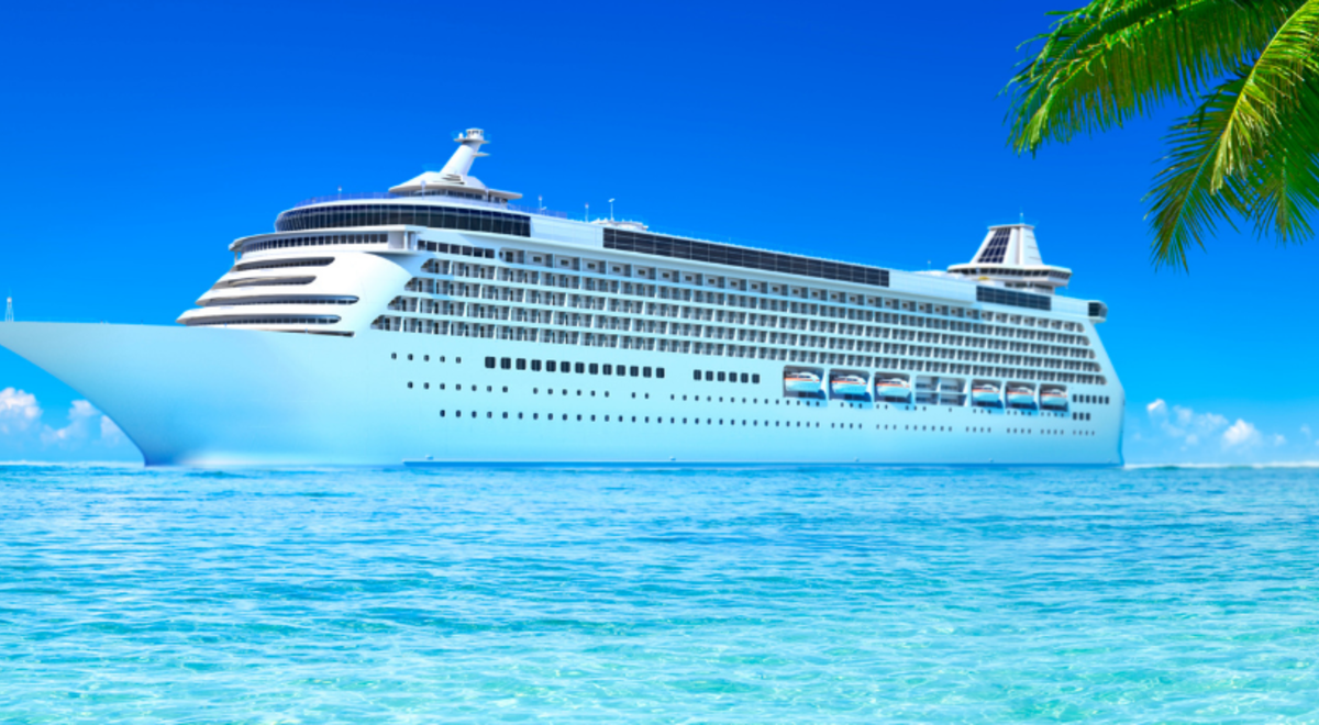 a cruise ship wandering on crystal clear blue waters near a tropical island