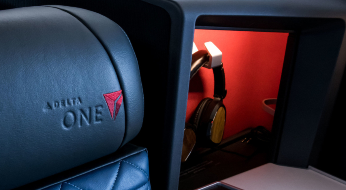 the head rest of the seat in Delta One Suites with a noice cancelling  headphone near it