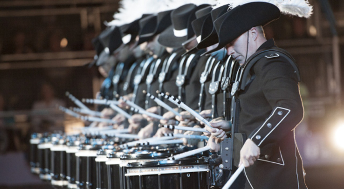 Marching band wearing matching black uniforms