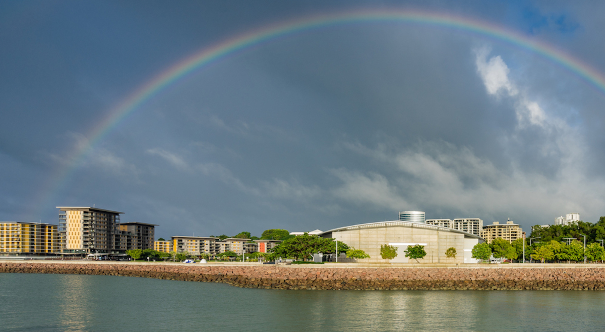 A rainbow in the sky over the water 