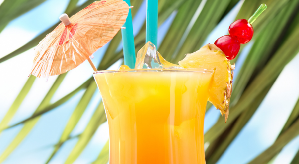 Refreshing yellow tropical drink with a decorative umbrella
