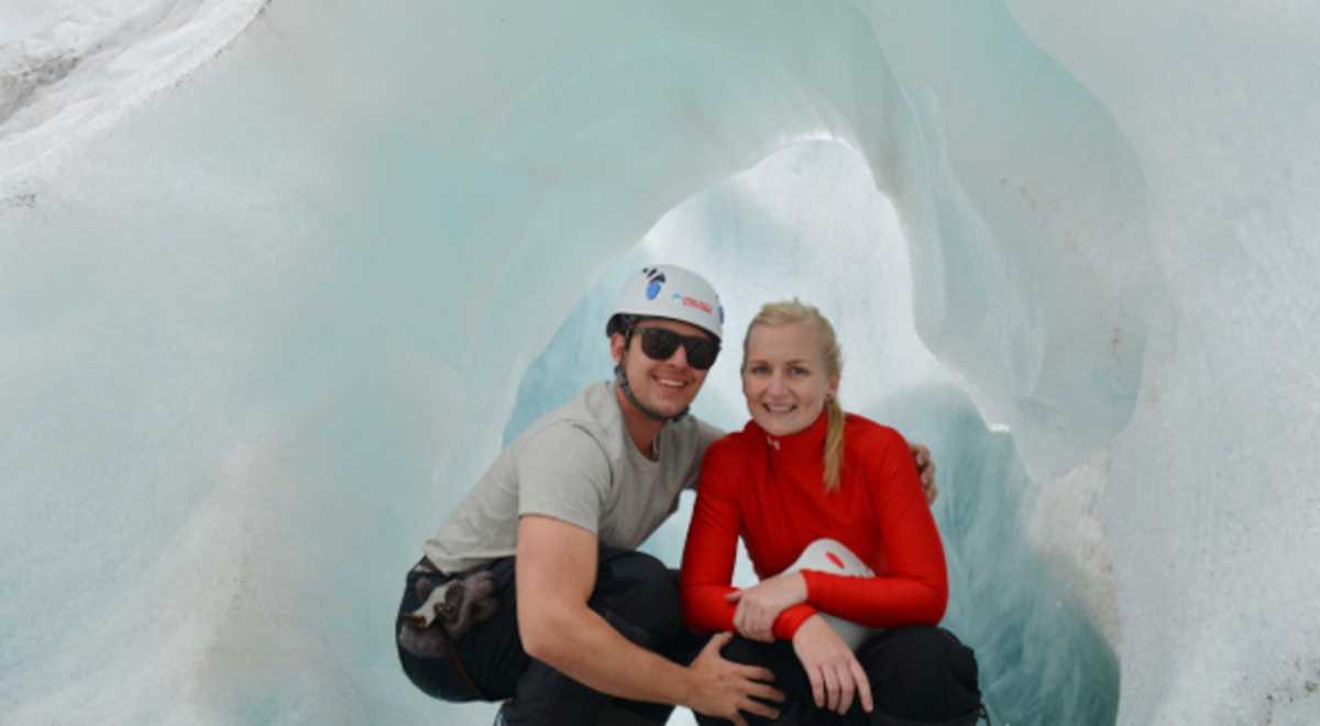 Happy couple has their photo taken inside an ice tunnel