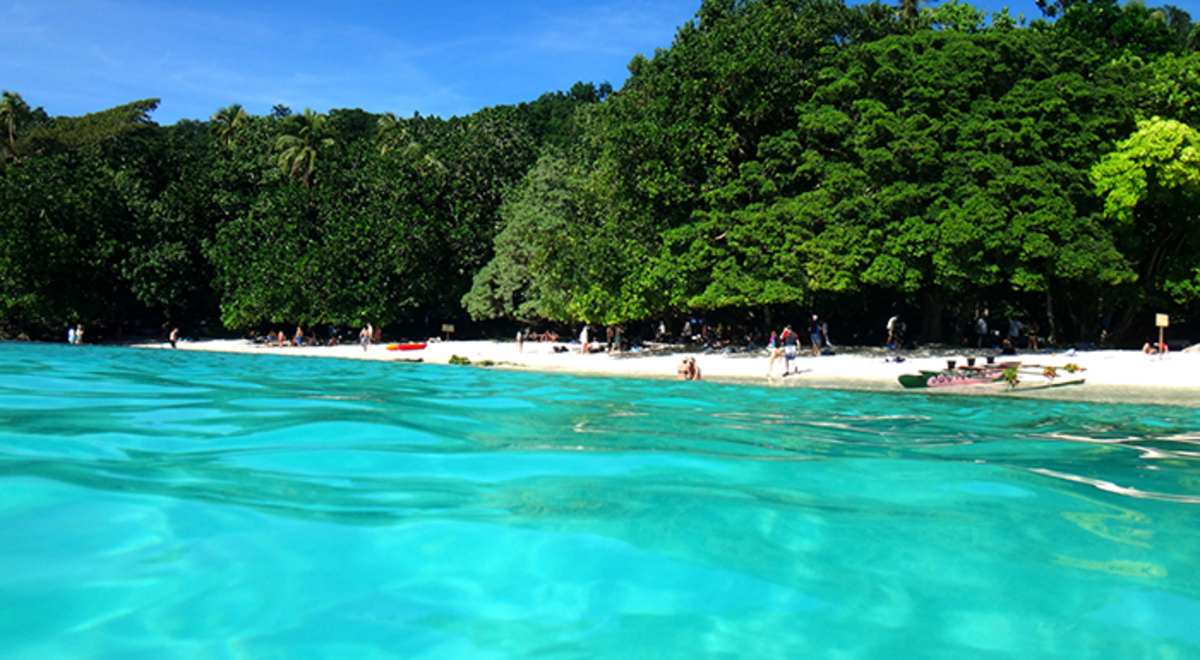 People unwinding at the shore of Champagne Bay, Vanuatu