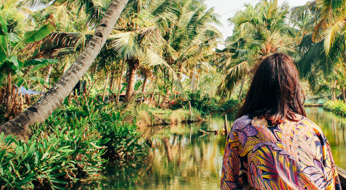 Lady in front of a boat enjoying a river cruise