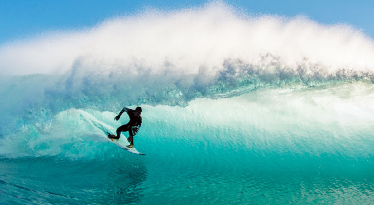 Surfer riding breaking wave
