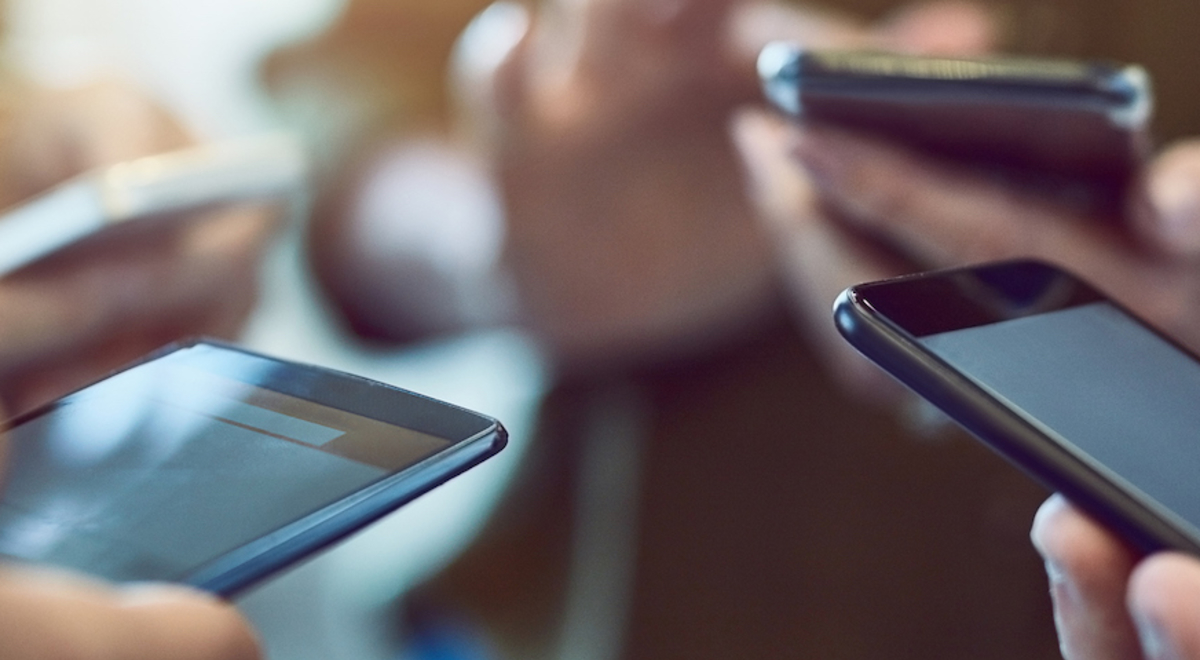 Four people on their phones 