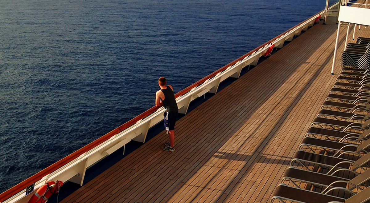 Guy looking at the sea from a ship 