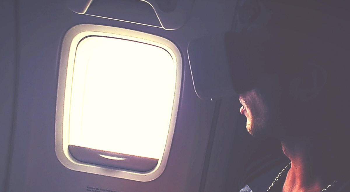 Man using a virtual reality headset on a plane