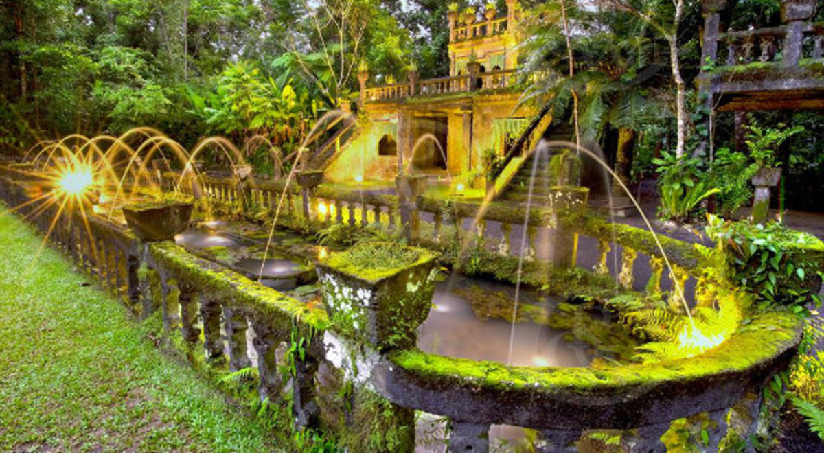 The foliage-covered lower Refreshment Rooms at Paronella Castle look beautiful floodlit at night