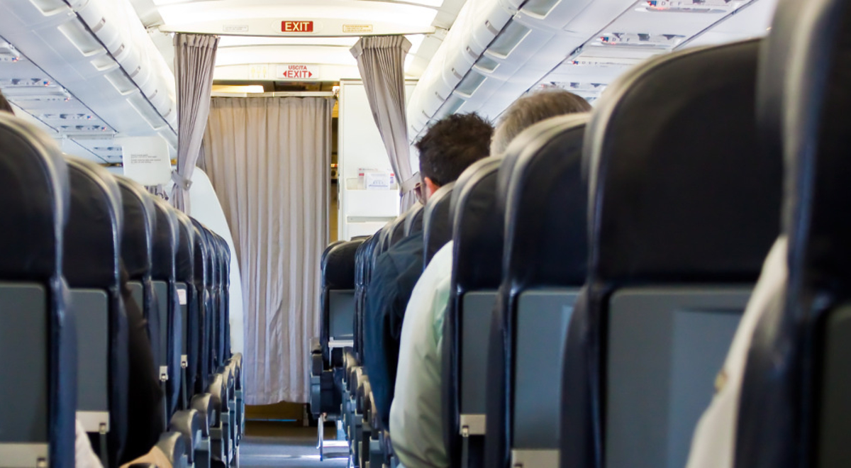 Looking up the aisle of an airplane, going back to front