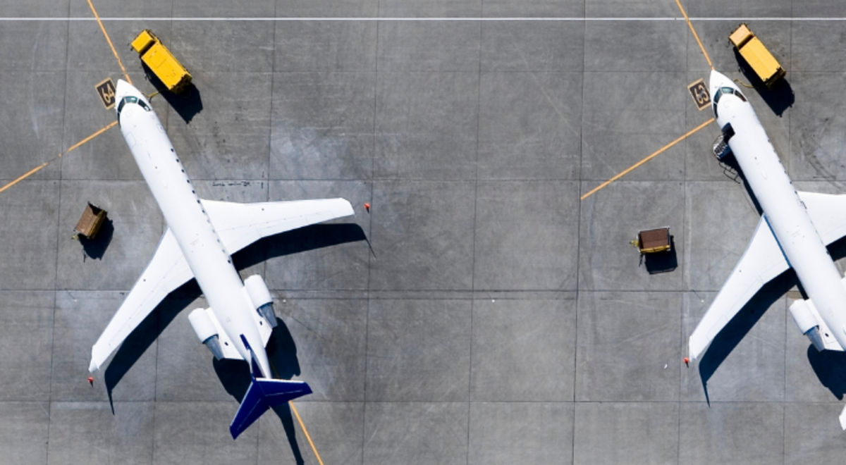 aerial view of three white airplanes parked at the airport