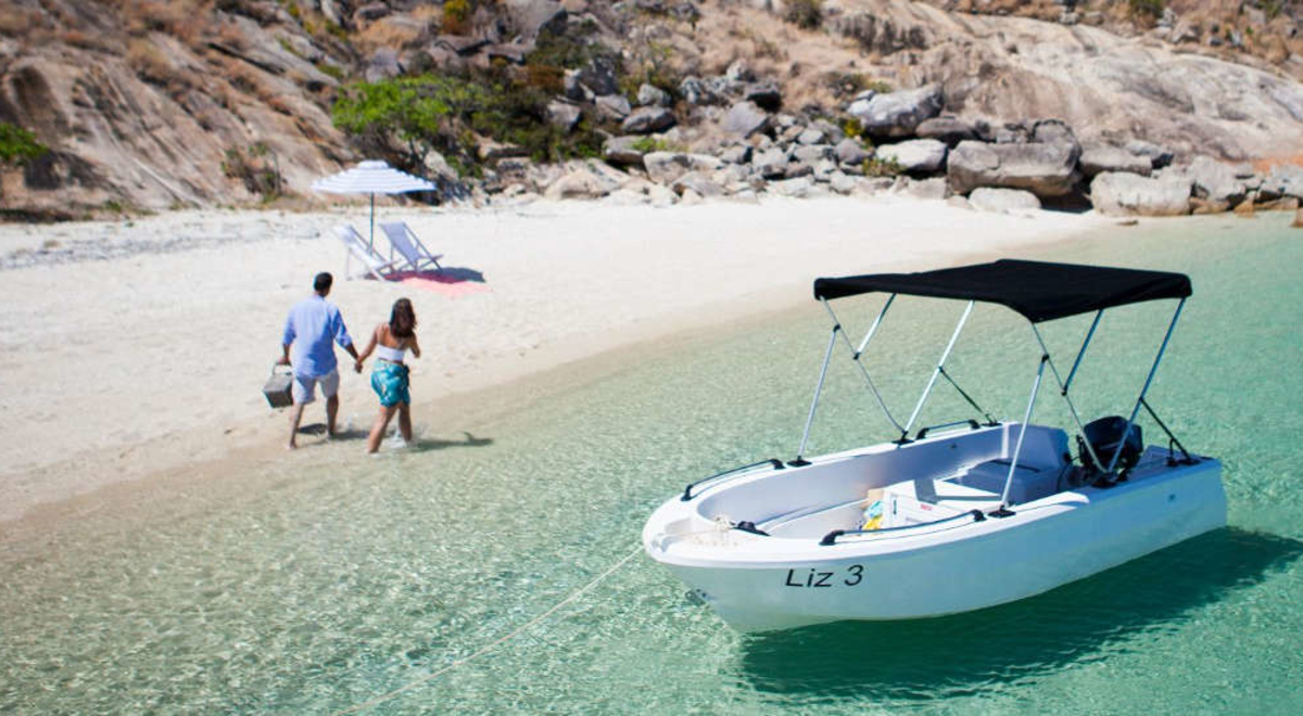 couple having picnic on secluded beach on lizard island qld