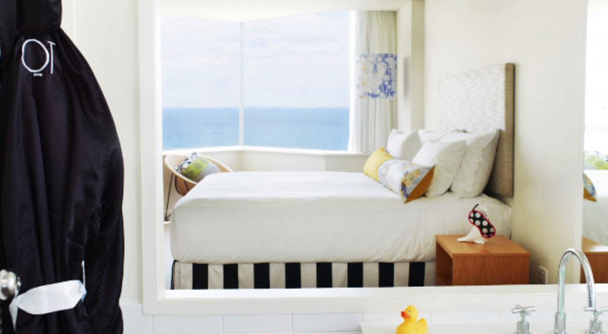2-person bedroom with windows overlooking the ocean