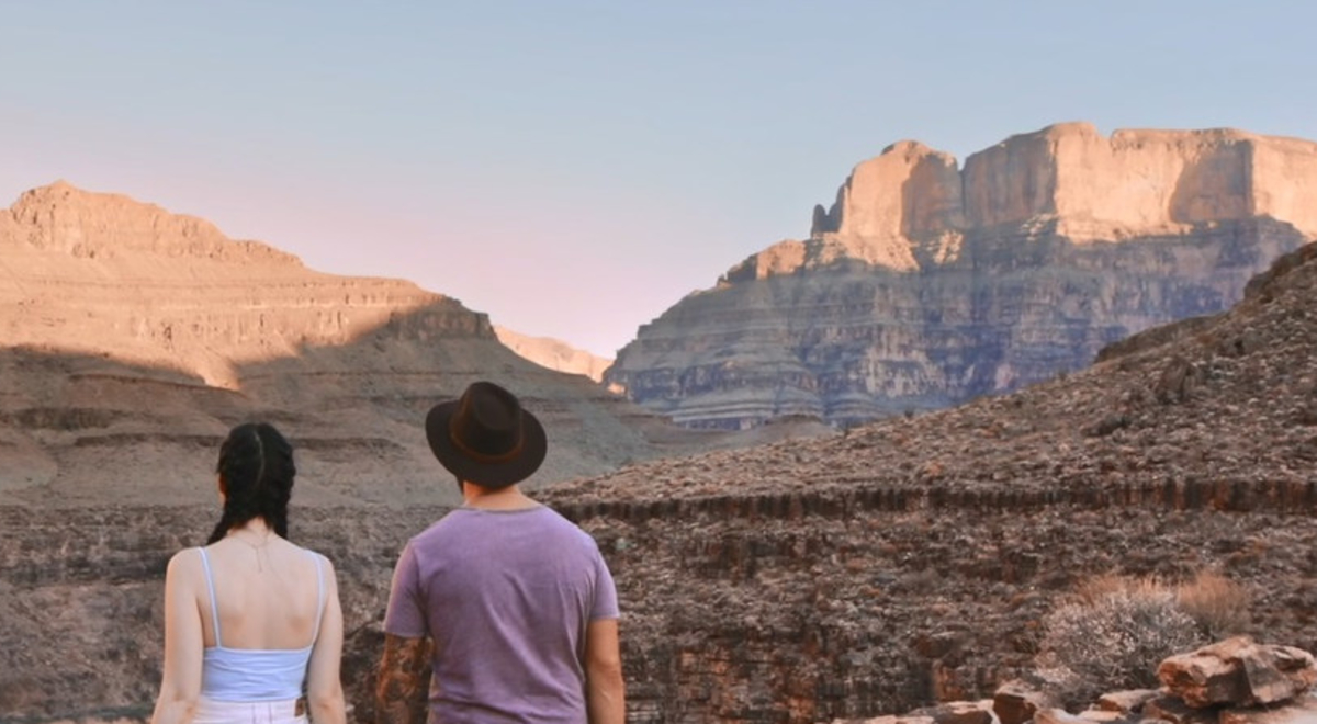 Two travellers at Grand Canyon looking out into the distance