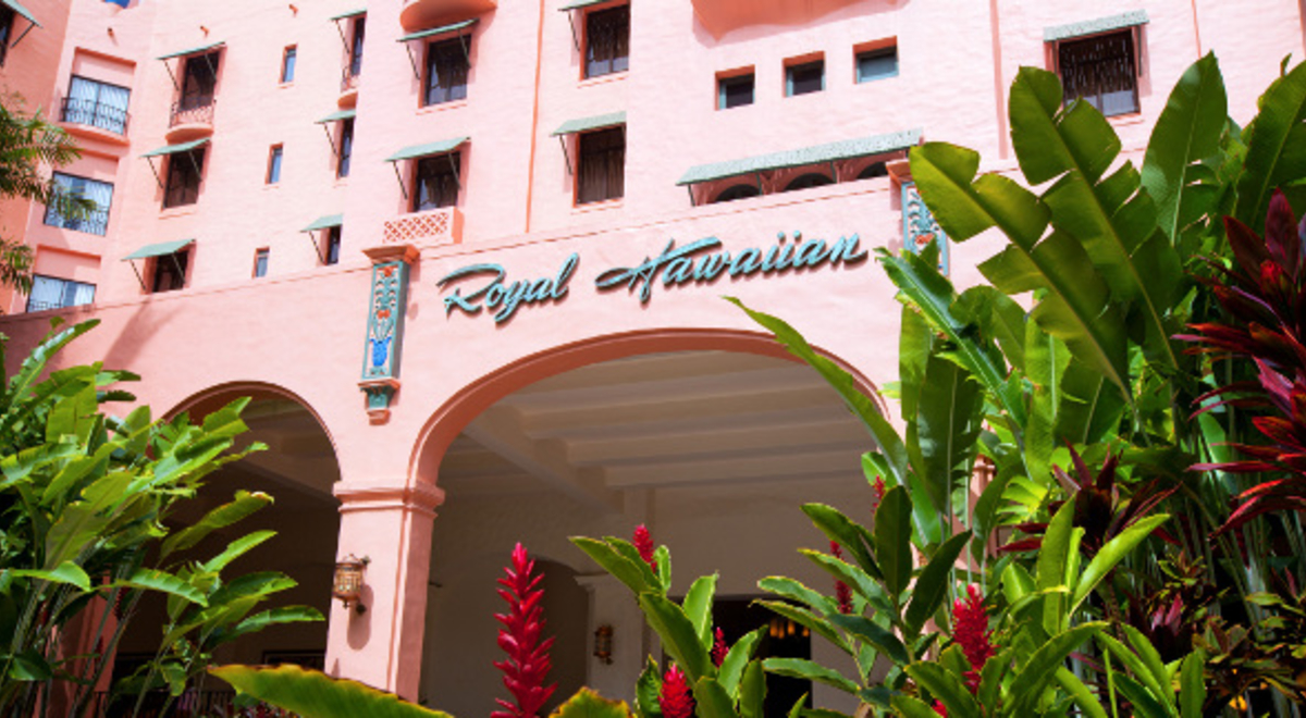 Royal Hawaiian Hotel in pink, with green and red plant decoration