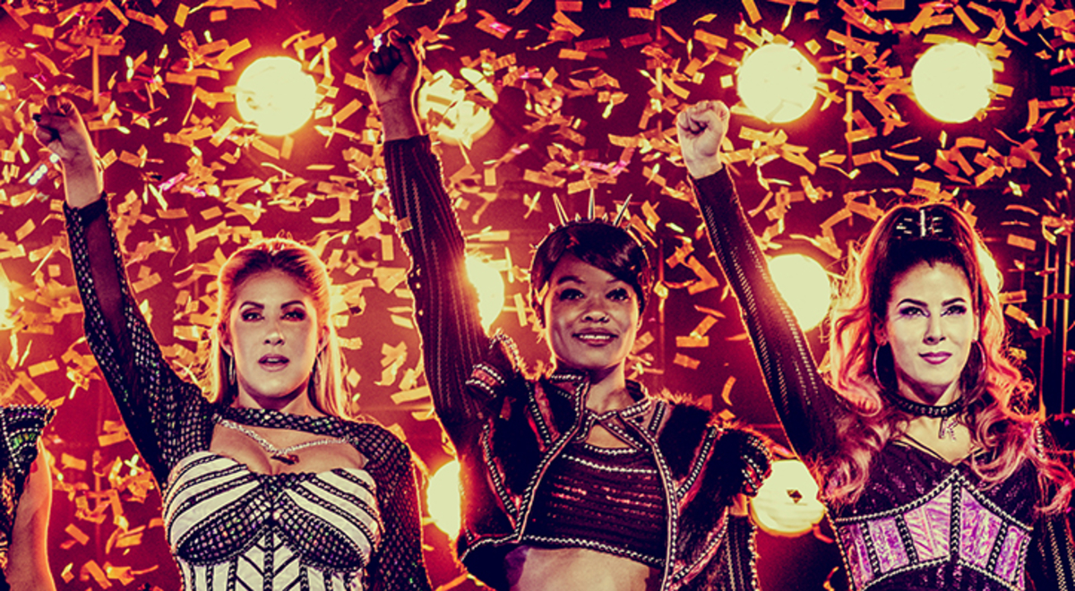 members of six the musical raised their fists after having their performance