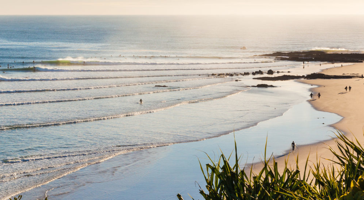 Aerial shot of a seashore with white sand beach