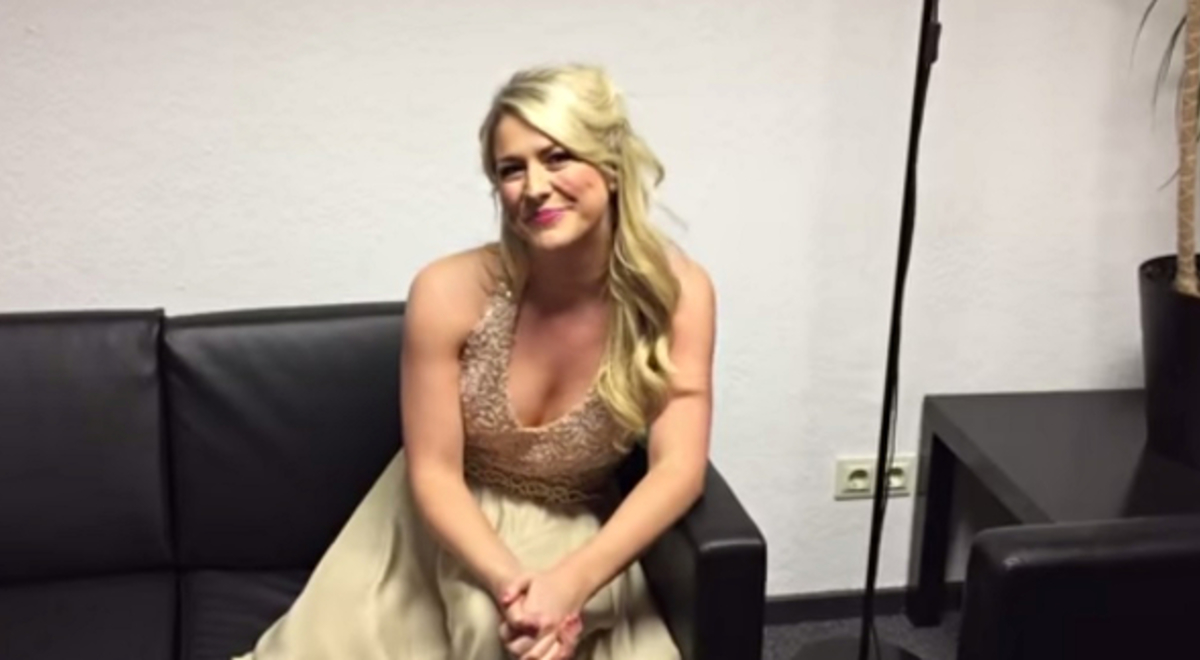 Susan Mcfadden sitting on the couch in gold dress 