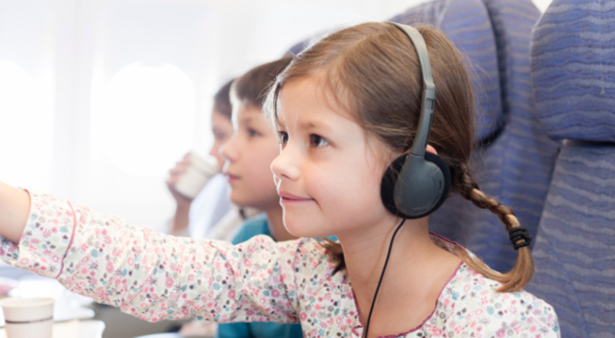 Young girl inside the plane accessing the TV airplane 