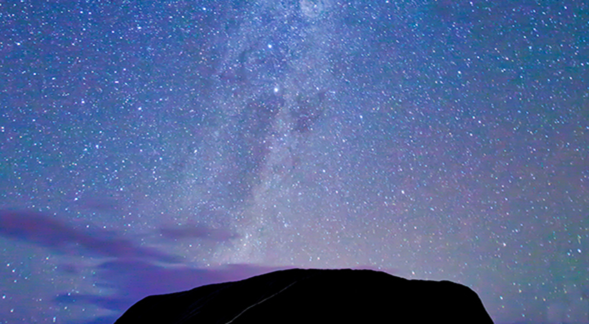 Star-studded purple sky  and a mountain silhouette