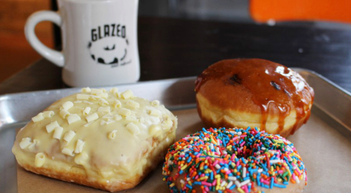 Mouth watering glazed doughnuts and a cup of coffee