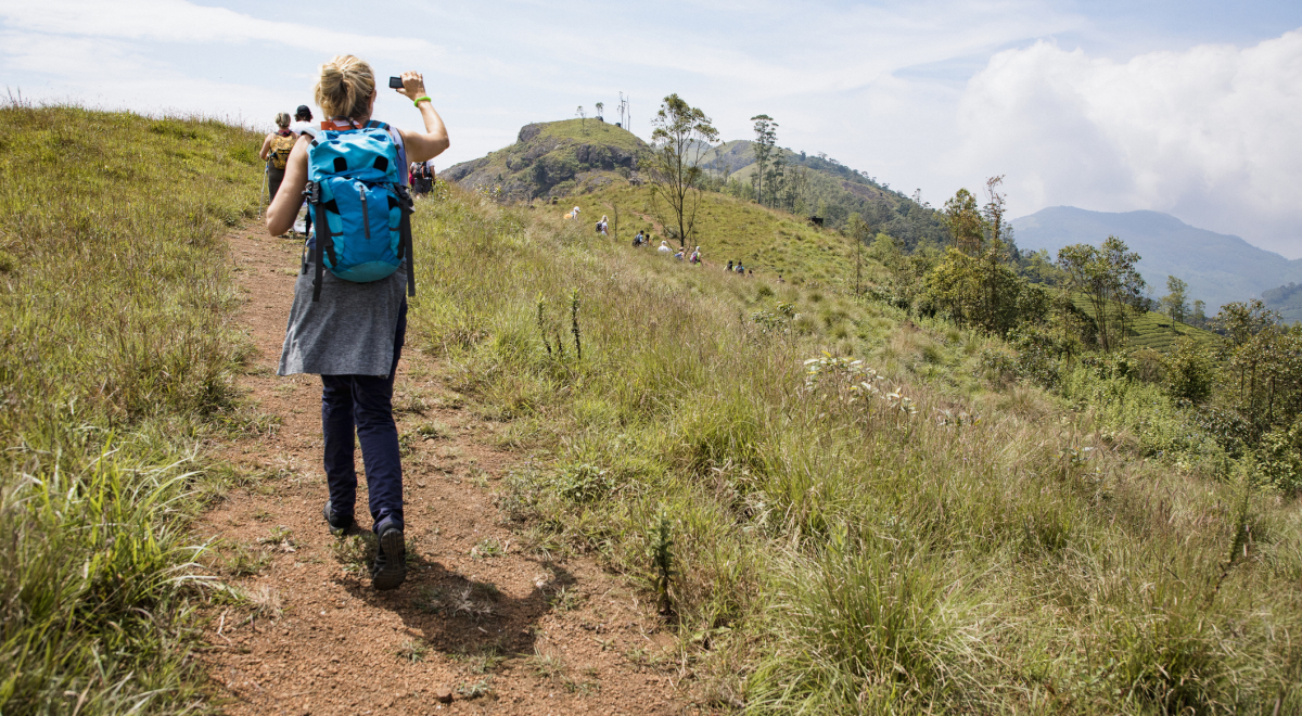 Hikers taking photos in the grass 