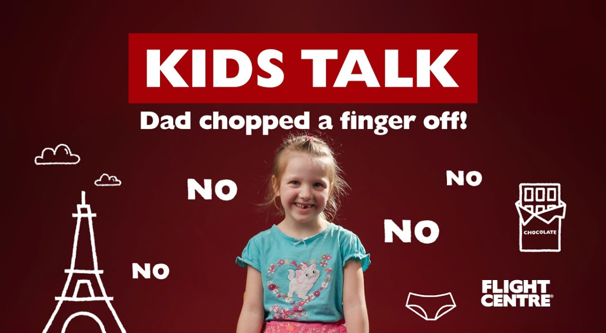 girl sitting next to graphics of no and Eiffel tower.