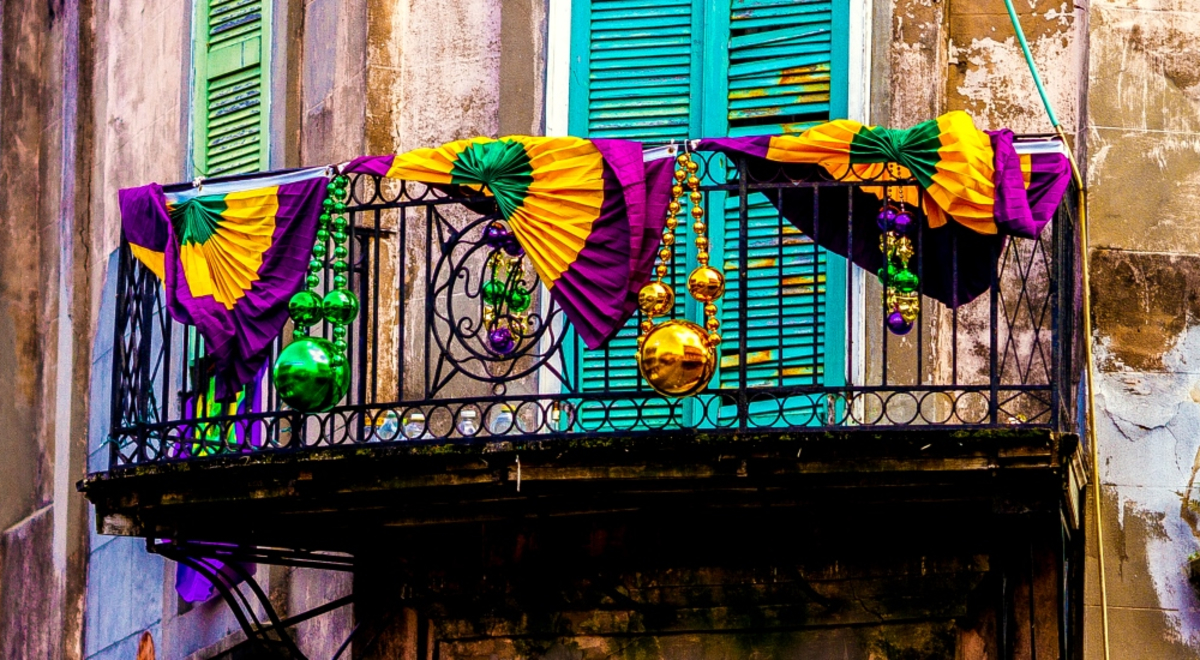 Colourful decorations hanging over balcony in old city street