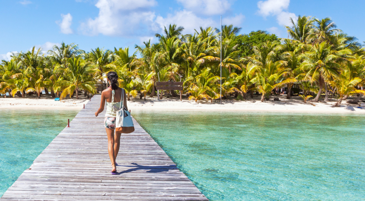 Woman walking on overwater pathway