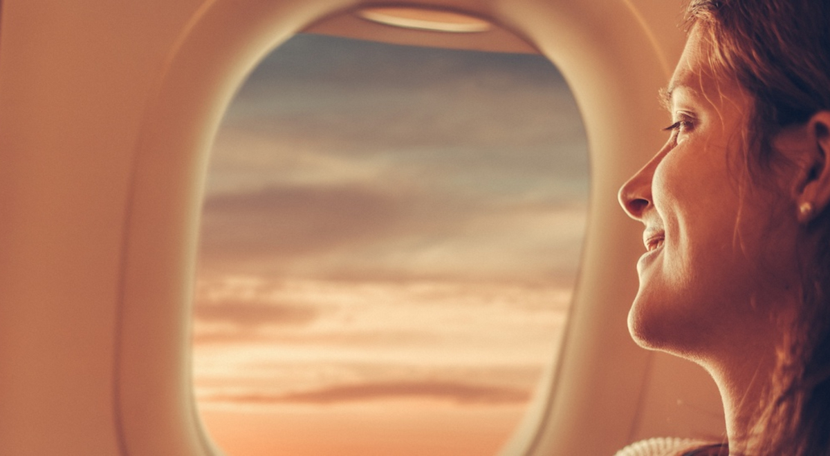 View of person looking out plane window