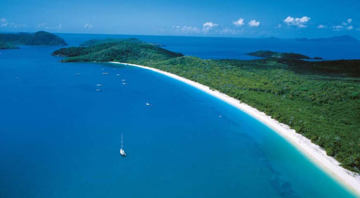 aerial view of white sandy beach and island in the Whitsunday islands Queensland