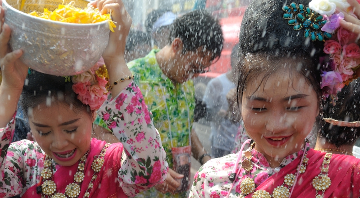 women carrying fruit in bowls on heads in Bali