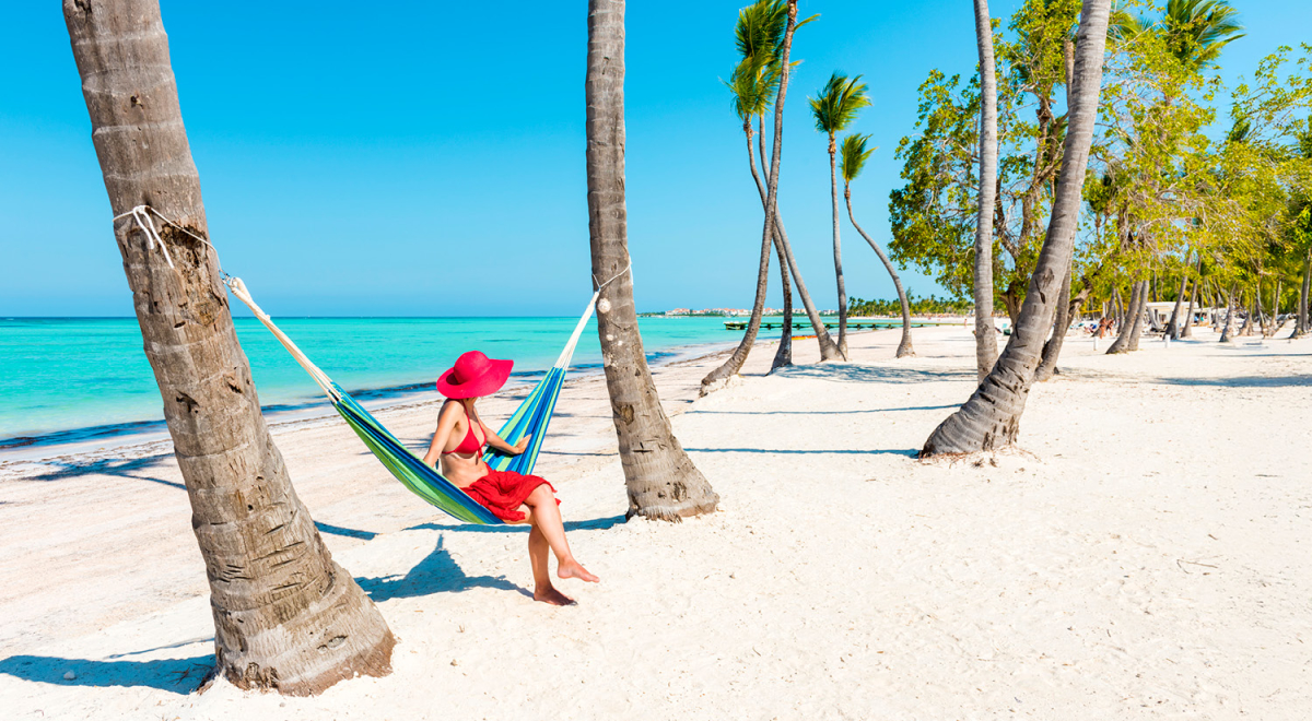 Woman relaxing in a hammock on a beach in the Dominican Republic