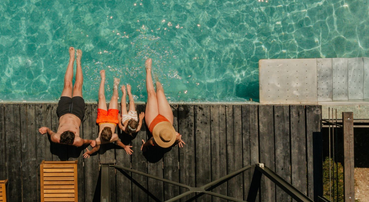 Family sitting at pool on spring break