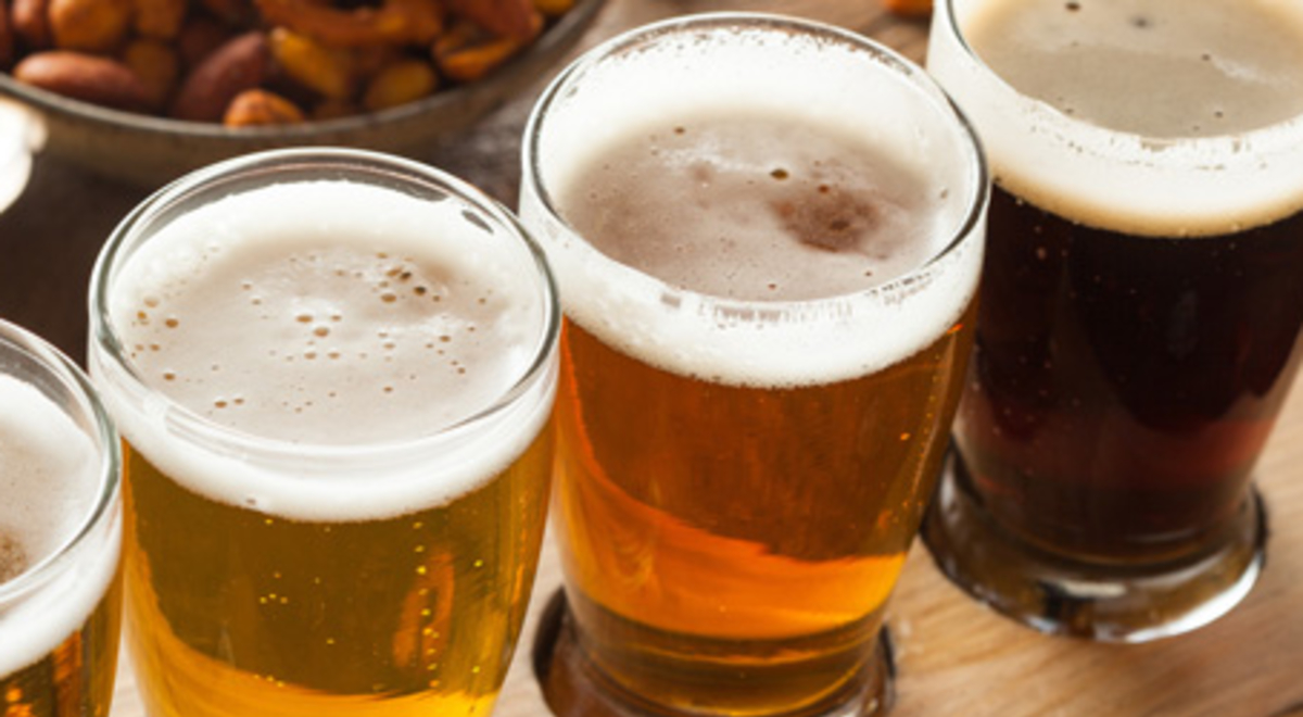 Four different types of beer on a table for tasting