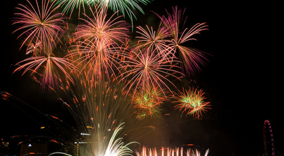 Red and green fireworks against the night sky