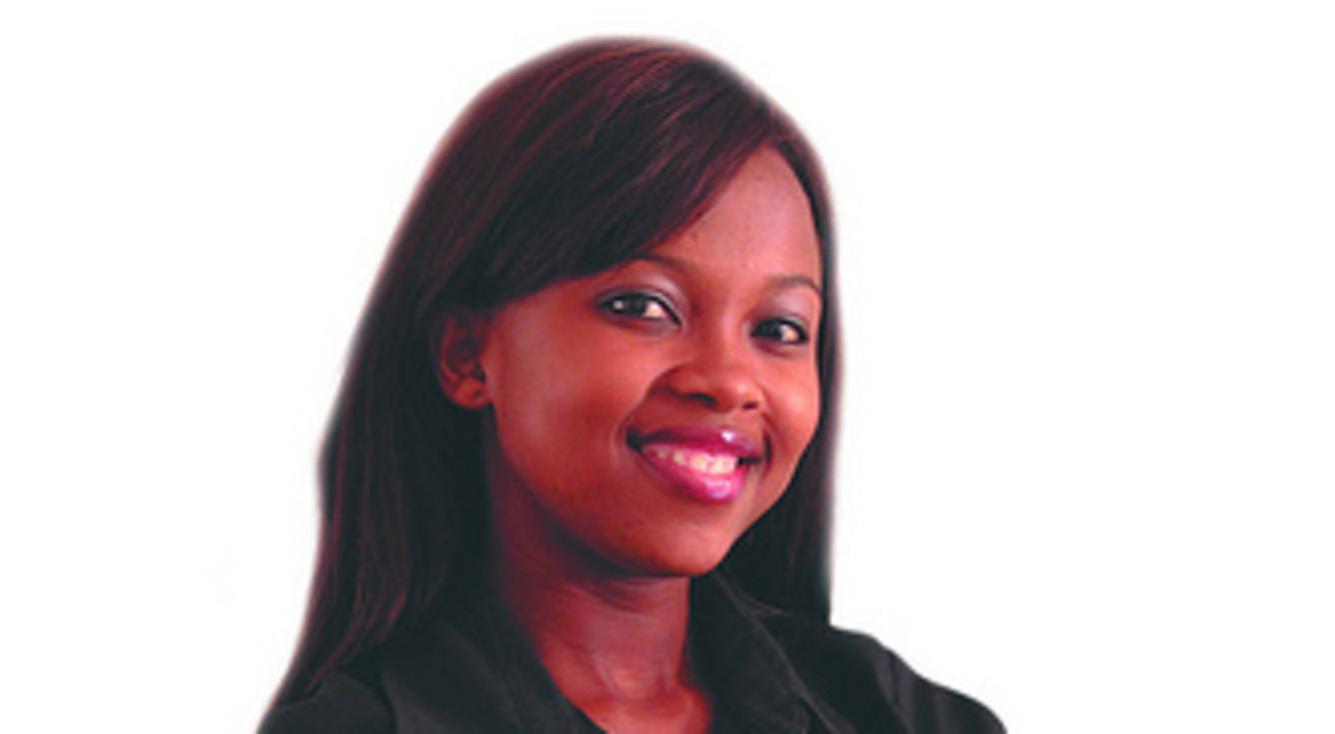 A woman folds her arms and smiles