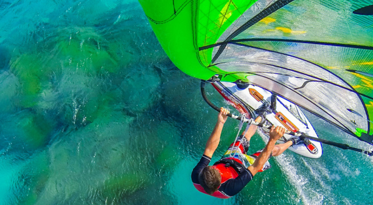 person paragliding over blue ocean