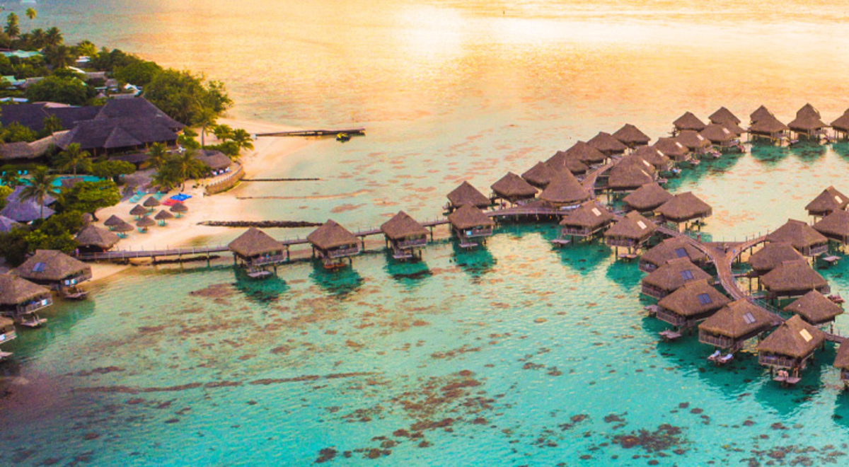 Aerial view of villas over clear blue water