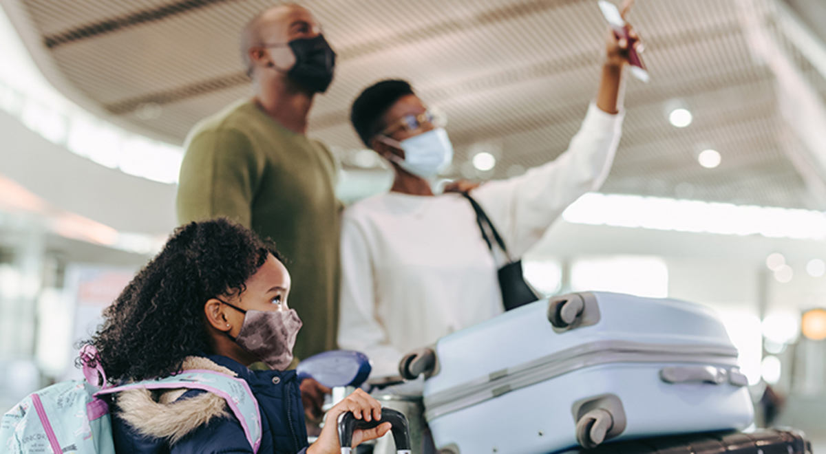 A family in the airport with their luggage