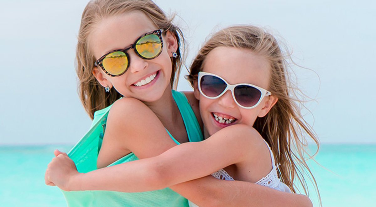 Two kids hugging each other on a beach