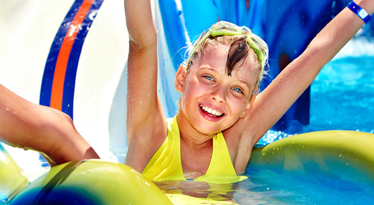 A young child going down a water slide