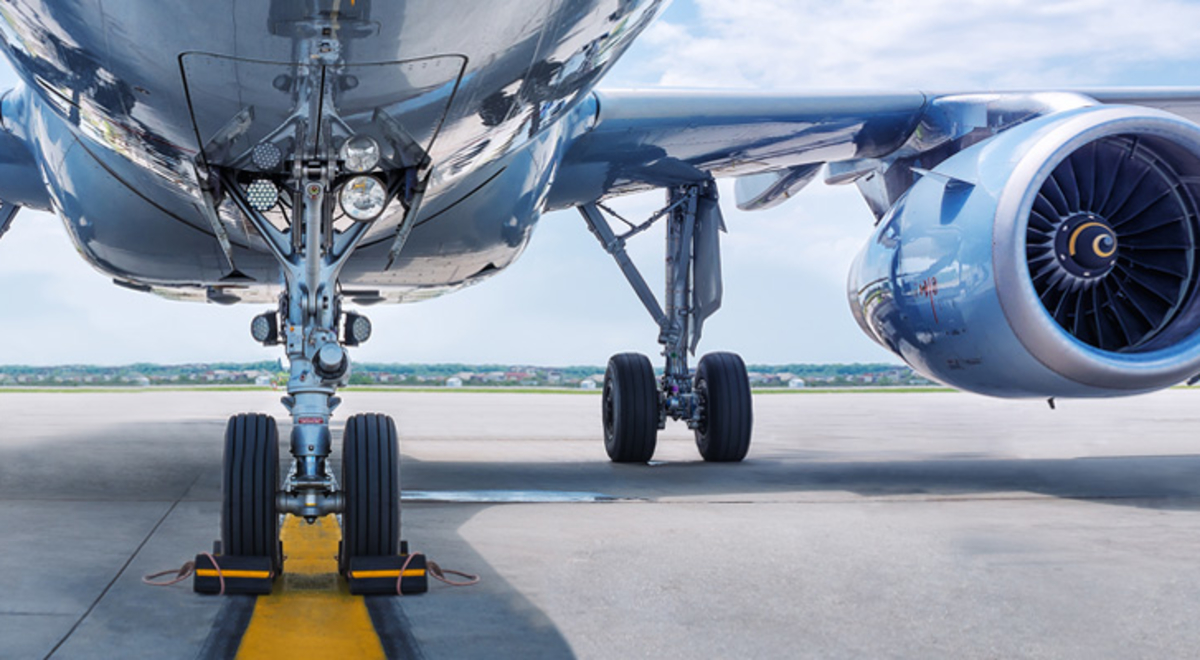 The underside of a passenger jet parked on the tarmac