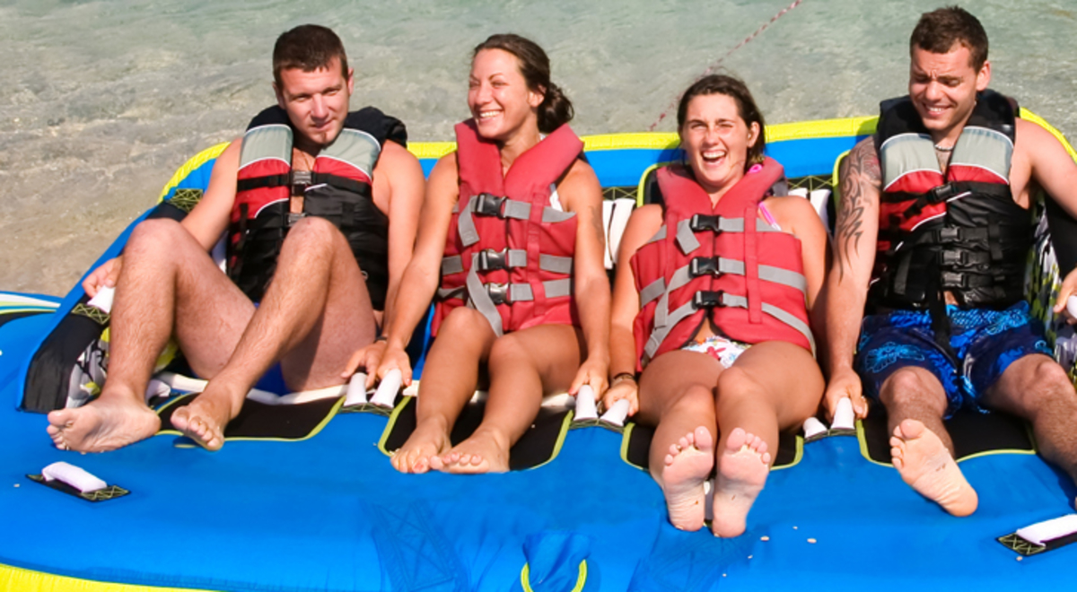 Group of four on tube at the beach 