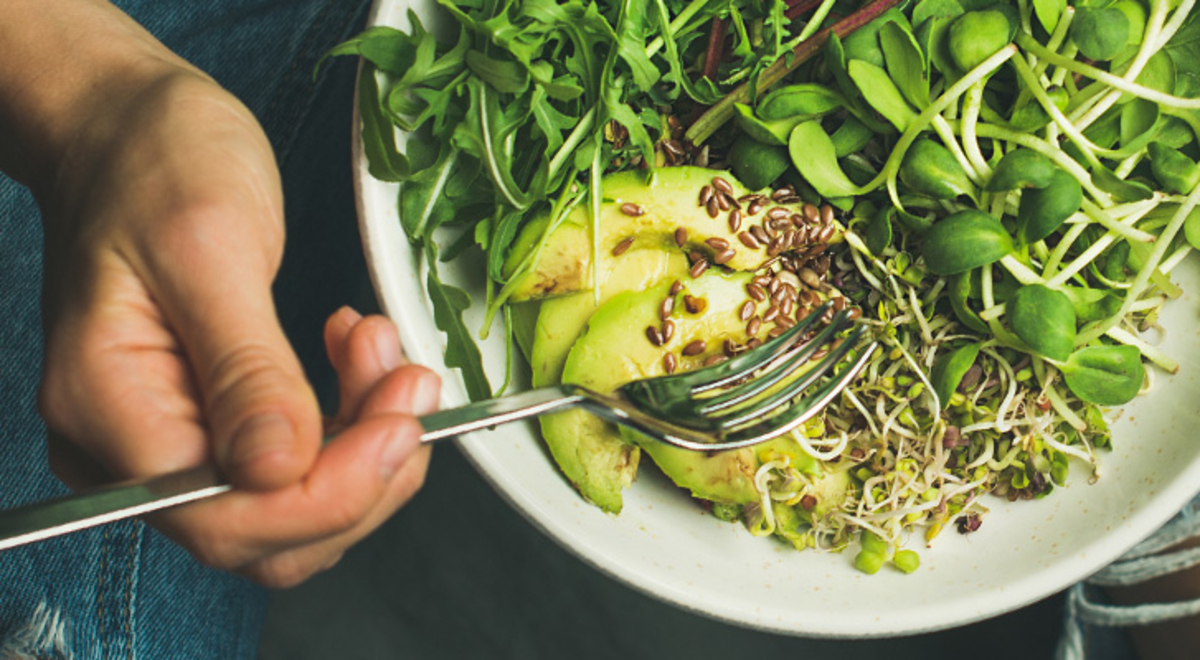 A person eating a bowl of food