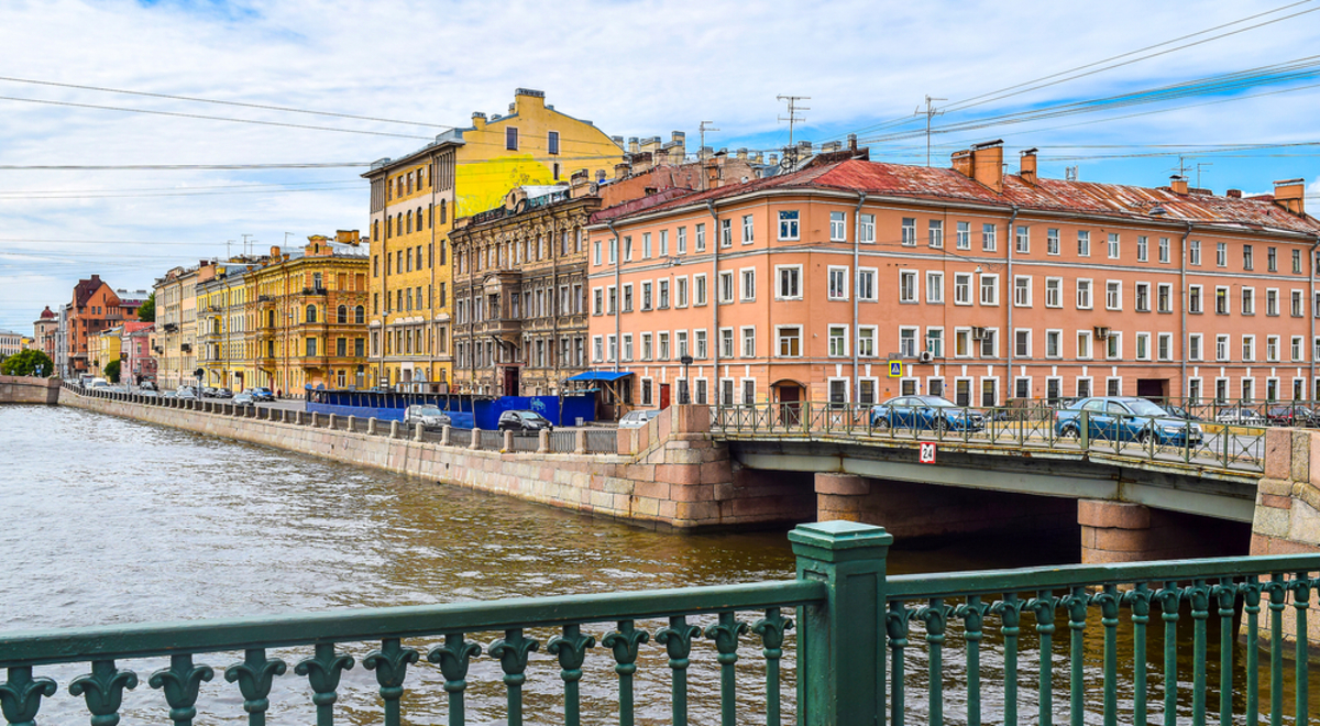 A view from a bridge over the Neva River, St Petersburg, Russia of cars crossing a bridge near waterfront buildings