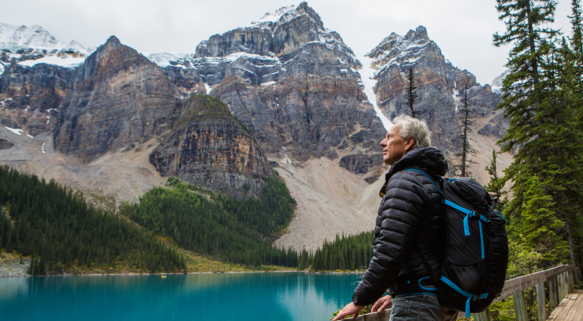 Man admiring view over lake and mountains in Canada